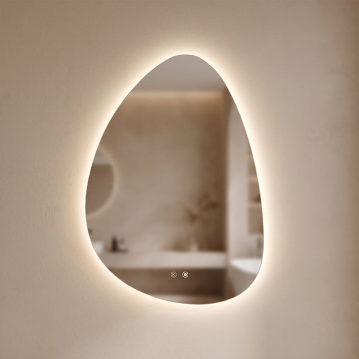 Pellora pebble-shaped LED backlit mirror glowing on a warm plaster wall