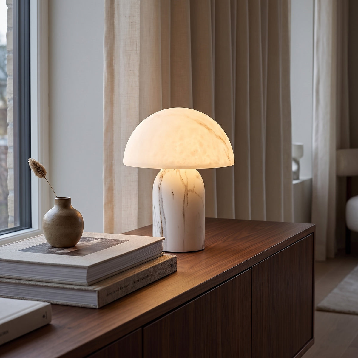 Aurisa mushroom lamp glowing on a walnut sideboard