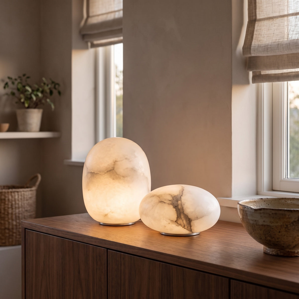 Tall and low Calmora alabaster lamps together on a sideboard