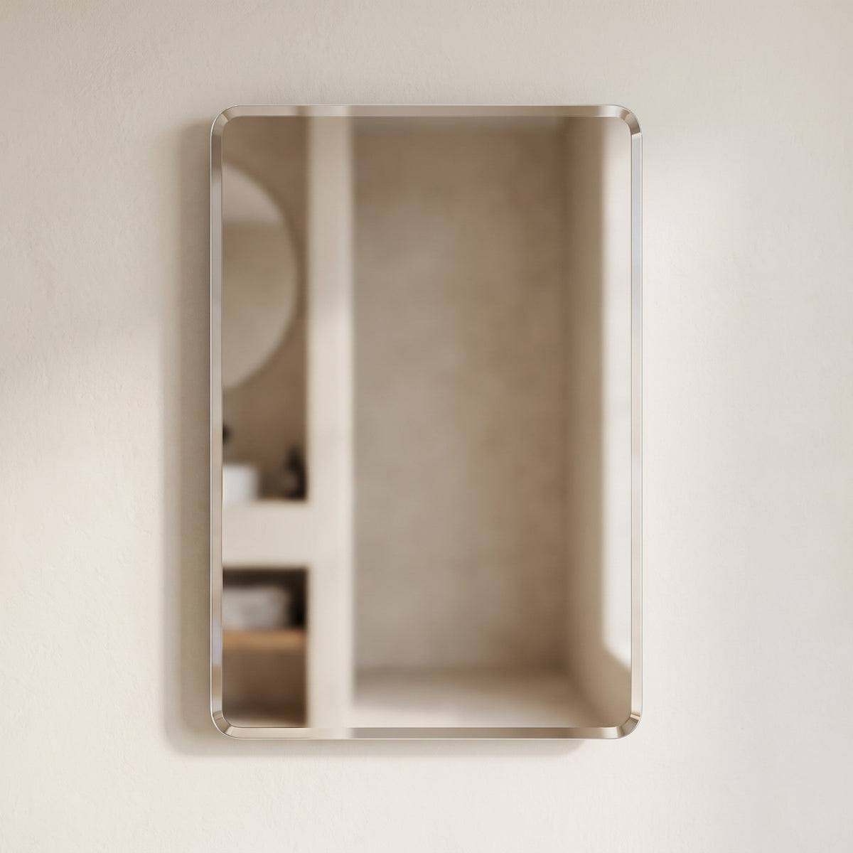 Curvelle frameless rounded-corner mirror on a warm plaster wall