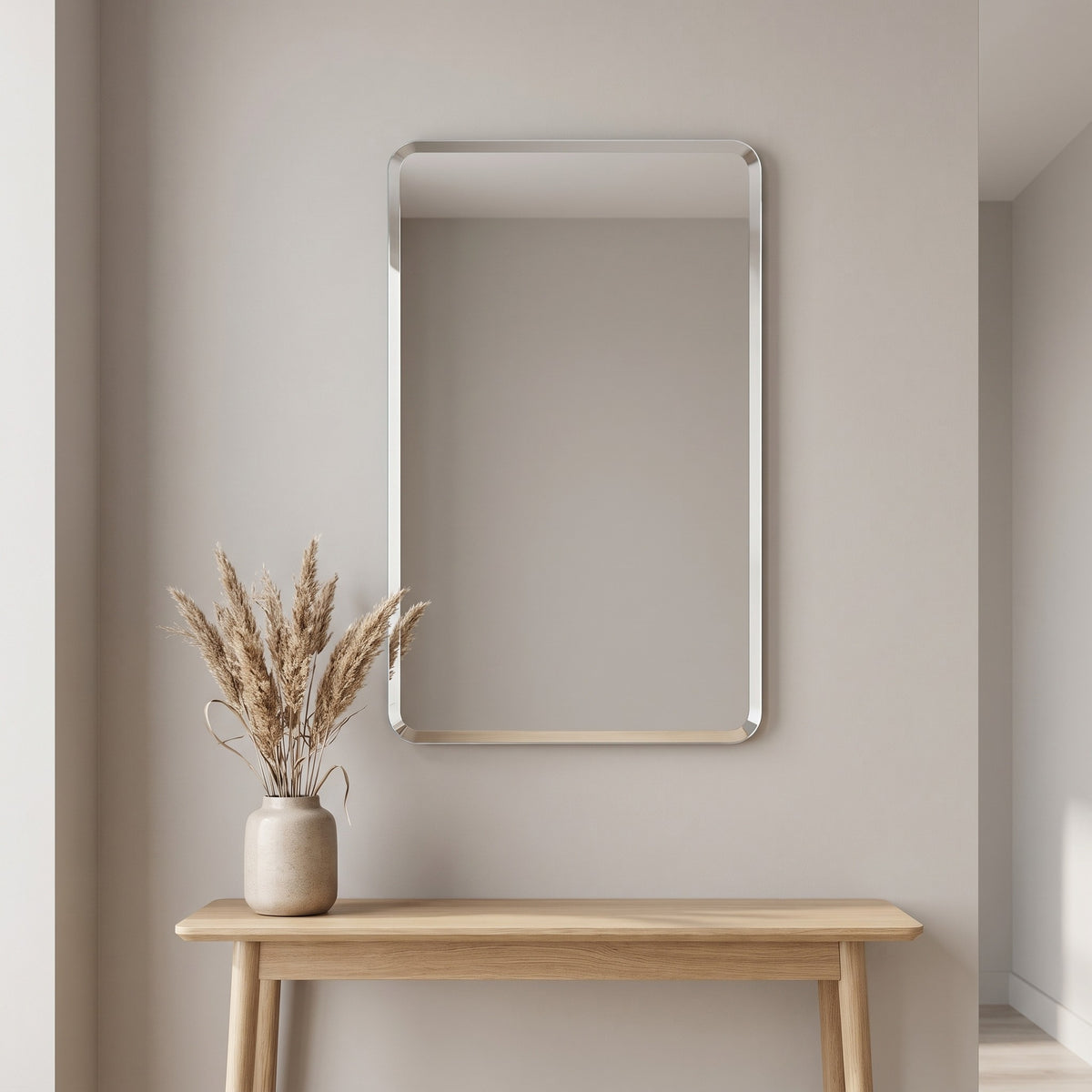 Curvelle frameless mirror above an oak console in a hallway