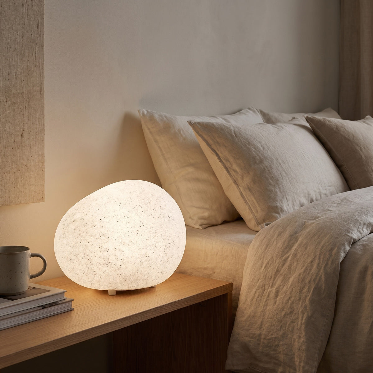 Lunara pebble lamp on a bedside table