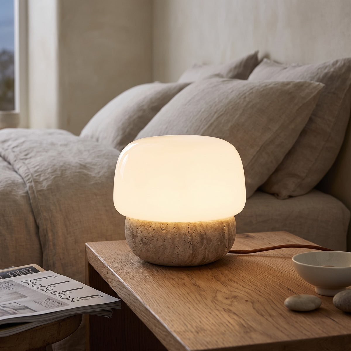 Morella mushroom lamp glowing on a bedside table