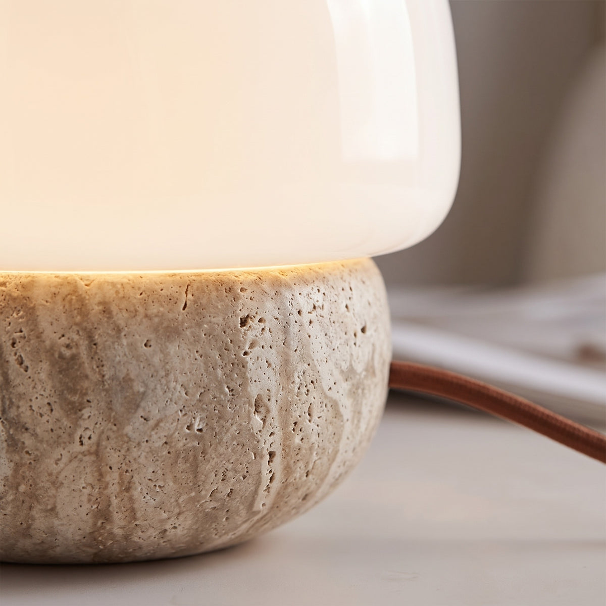 Close-up of the Morella travertine base and glass shade