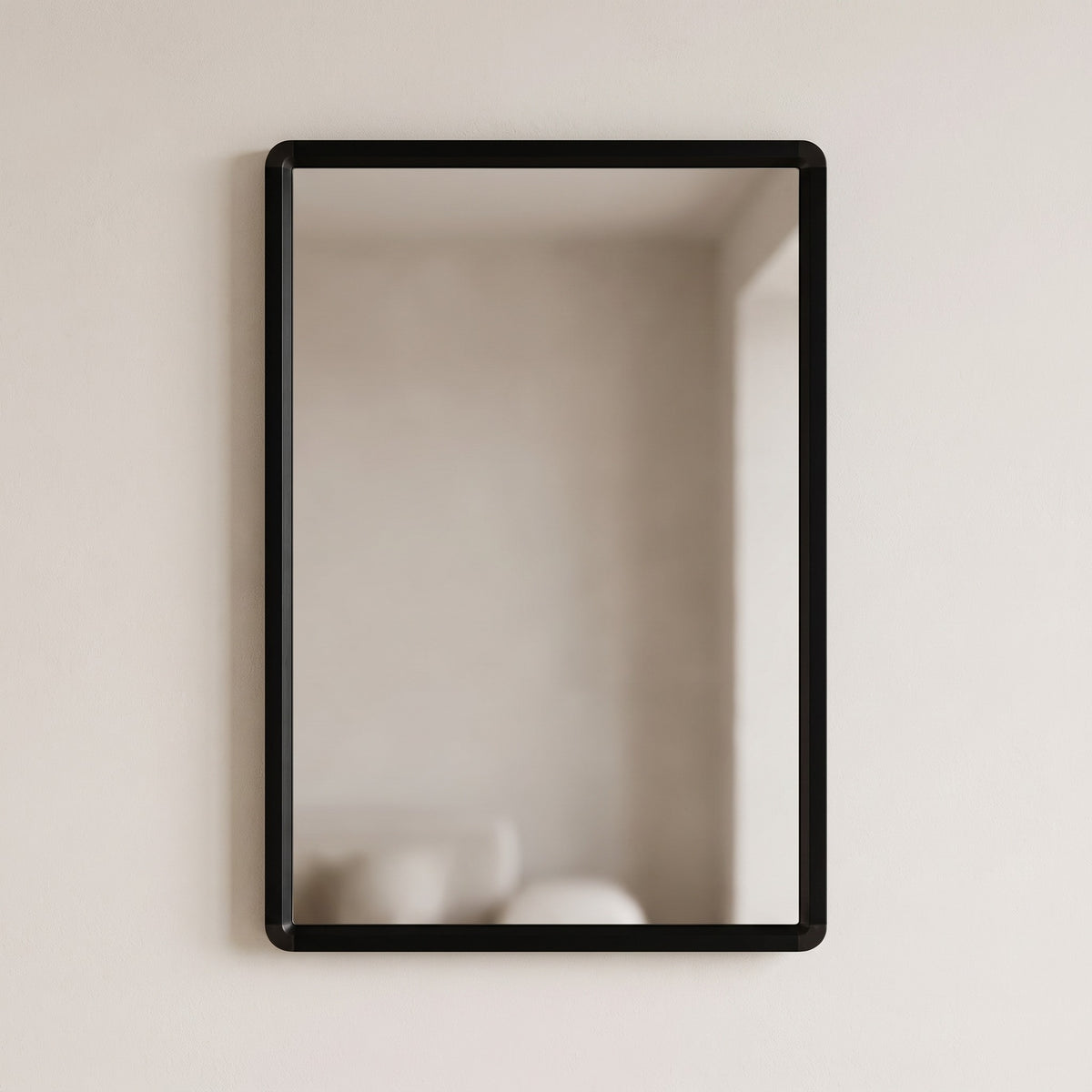 Sabelle black rectangular wall mirror on a warm plaster wall