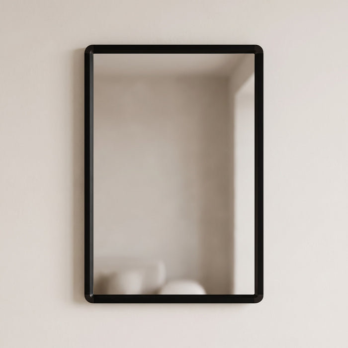 Sabelle black rectangular wall mirror on a warm plaster wall