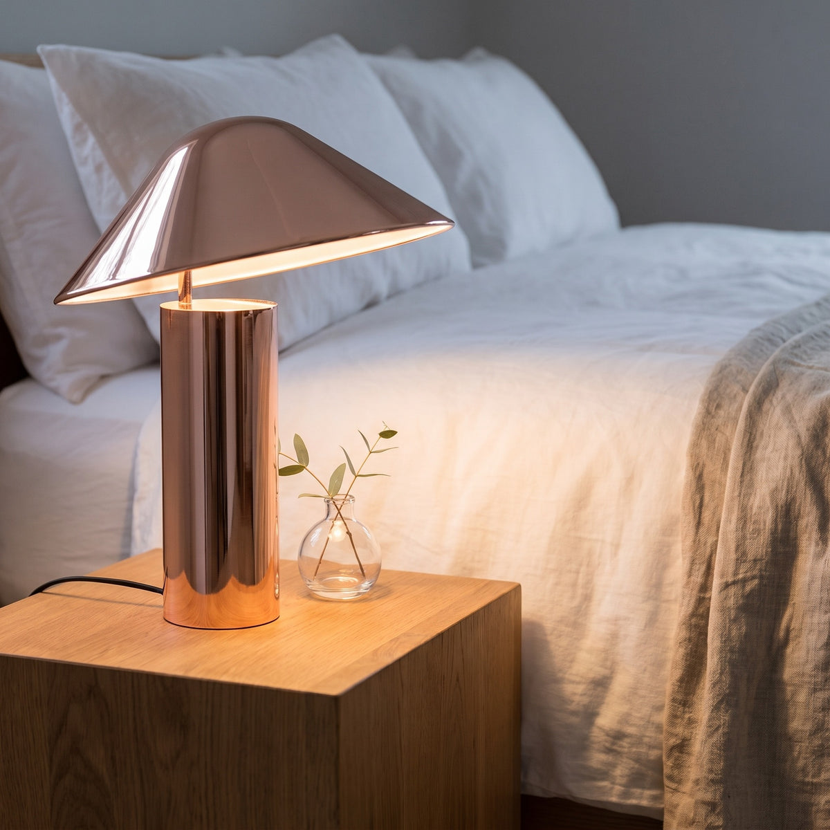 Rose gold Sorrelle table lamp on a bedside table