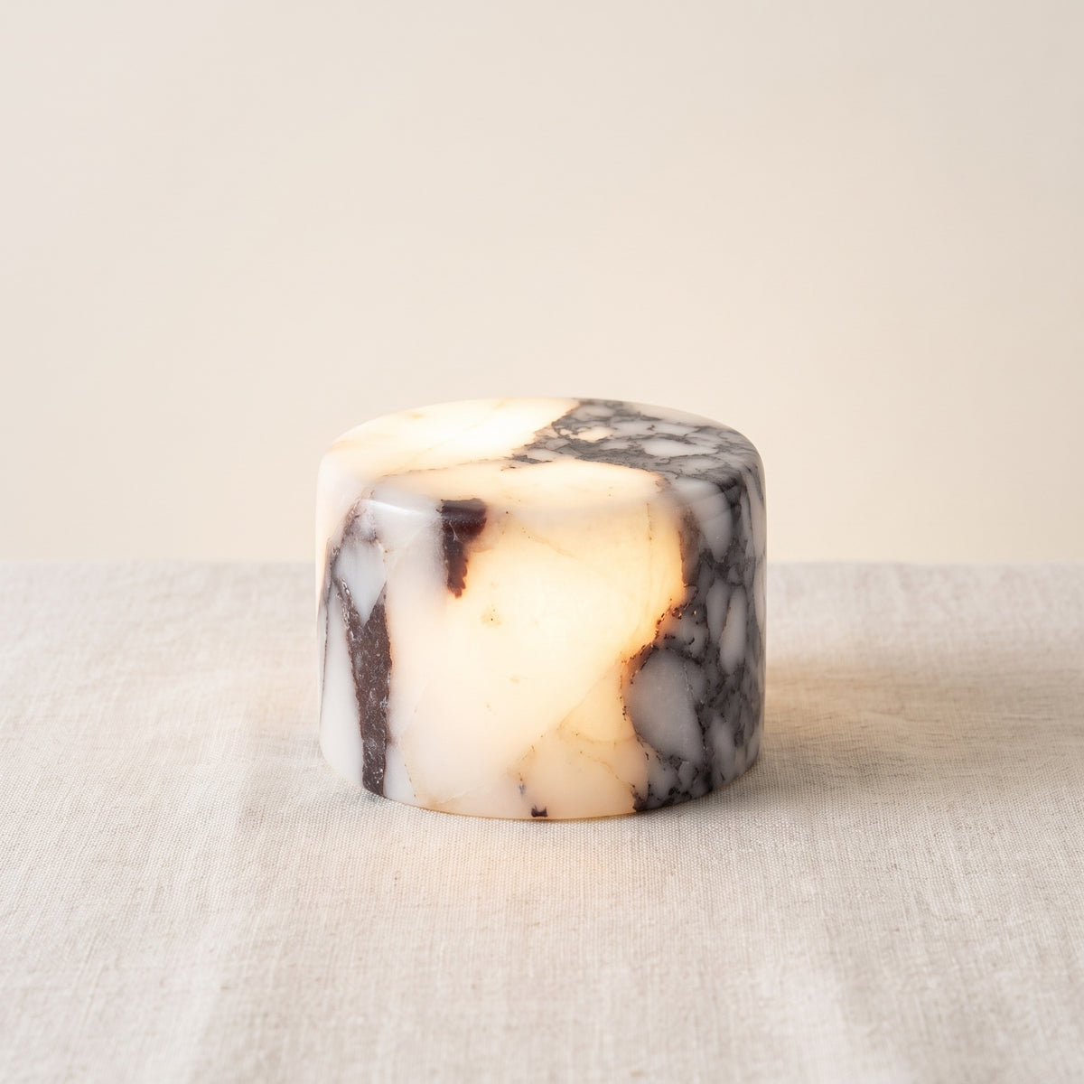 Veinora marble touch lamp in veined white marble, lit