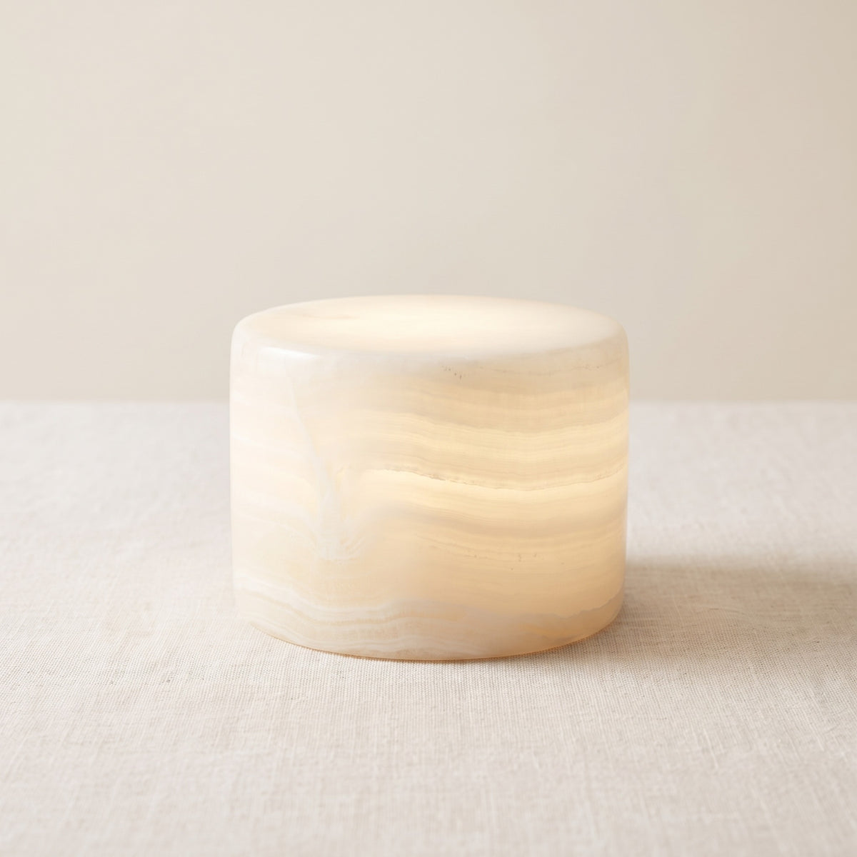 Veinora marble touch lamp in ivory banded marble, lit